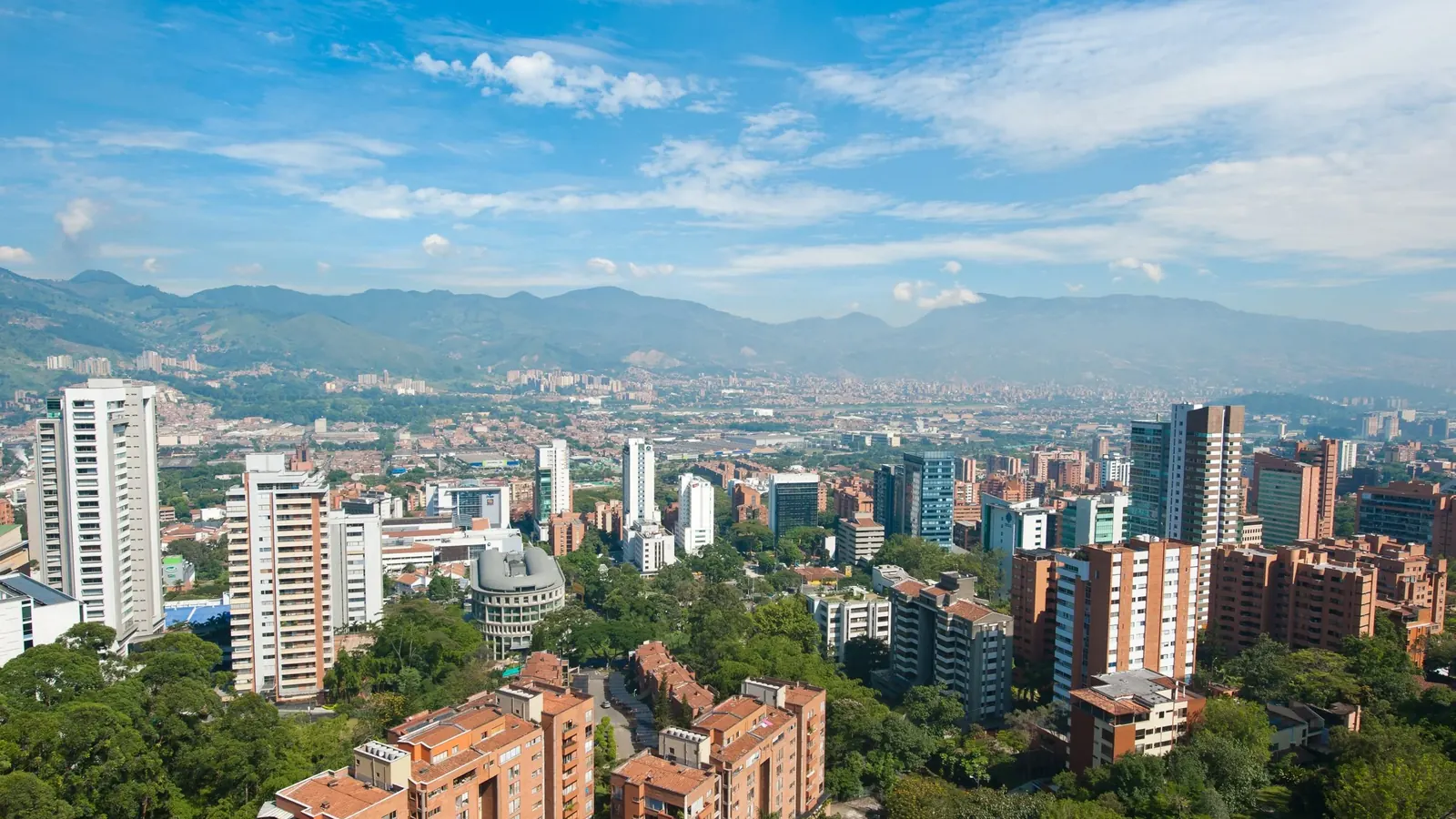 El Poblado from above, towers among trees with the valley behind